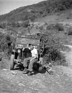 Kim with old Jeep,20,"Korea, area of 38th parallel",Kim,1954,Peter Anthony,"Kim with old Jeep;Korea, area of 38th parallel;Kim; 05/1905; Photograph by Peter Anthony"