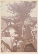 Robert E. Beveridge manning a machine gun on Highway 1; with caption "To Dad and Mom." Photograph taken in Phang Rang, Cam Rahn Bay, South Vietnam on 11/17/1966