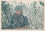 Robert E. Beveridge posing with a M60 machine gun in Bien Hao, South Vietnam in 1966