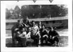 William Bormolini and barracks 14; 01/26/1944. William is furthest on the left leaning over.