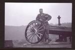 James R. Burns leaning on wheel with �Keep em rolling� on it.  Burns was in the motor pool part of the unit � 1952/1953