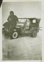 Normand Henry Carleton sitting on jeep during heavy snowstorm Herbitzheim, France February, 1945