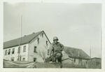 Normand Henry Carleton on top of Half-Track (Note white surrender flag in window of house in background) Frankenbach, Germany April, 1945