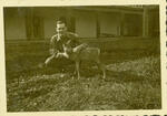 Normand Henry Carleton with the 315 FA BN mascot, a pet deer Sonthofen, Germany September, 1945