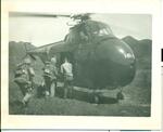 Men boarding a Sikorsky helicopter. Sgt. Clement says this was the first use of helicopters to bring troops to the front. Korea, Spring 1952