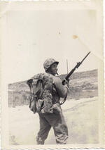 Sgt. Douglas Clement wearing his heaviest pack and carrying his rifle. Korea, Spring 1952.