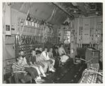 US Navy photograph of Dyle elementary schools 5tyh grade class in bay of Natwingpac C-130 aircraft ; Cupertino, CA; 28 April 1964