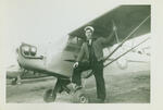 Waukegan, Il, air field, Joseph Diani standing next to Piper J3 airplane, 1953