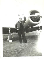 Waukegan, Il, air field, Joseph Diani holding prop of  Piper J3 airplane; 1953
