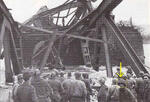 Soldiers from the 988th Engineer Treadway Bridge Company, of the 297th Engineer Combat Battalion, looking at the remains of the Ludendorff Railroad Bridge (Remagen) as attempts are made to rescue soldiers who were on the bridge when the German Army detona