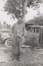 Hank Fregueau, in front of a pre-war Japanese army staff car in which four Japanese officers were killed. Luzon, Philippines, 1945