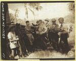 1st Battalion, 164th Infantry commanding officer and his company commanders hold consulting talk with guerrilla regimental commanding officer before American passage through Filipino lines; Philippines; 1945; photograph taken by the U.S. Army Signal Corps