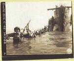 1st Battalion, 164th Infantry wades ashore; Looc, Negros Oriental, Philippines; April 26, 1945; photograph taken by the U.S. Army Signal Corps