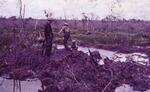 Patroling a bomb crater. All unknown; Vietnam; 02/10/1969-02/08/1970