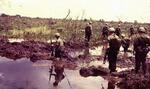 Patroling through the mud; Vietnam; 02/10/1969-02/08/1970