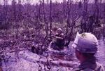 Patroling through the mud; Vietnam; 02/10/1969-02/08/1970
