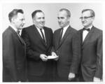 Ralph M. Rooke, Eugene Marquette, John W. Addley, and Herbert E. Angell at check presentation
