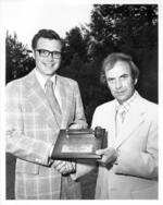 Rolf H. Olsen recieves plaque with gavel as University of Hartford Alumni Association President, 1975-1975.