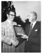 Hector C. Prud'homme receives plaque as Honorary Alumnus